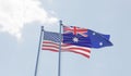 USA and Australia flags waving against blue sky. Royalty Free Stock Photo