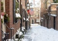 Acorn Street in the snow with the American flag flying