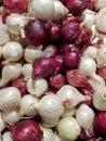 Small red & white pickling onions piled up in a local grocers