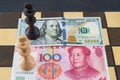 USA and China financial trade war concept, black and white chess king on US dollar and RMB banknotes Royalty Free Stock Photo