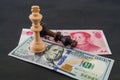 USA and China financial trade war concept, black and white chess king on US dollar and RMB banknotes Royalty Free Stock Photo