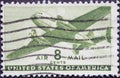 USA - Circa 1944: a postage stamp printed in the US showing a twin-motored transport airplane 8c airmail