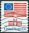 USA - CIRCA 1975: A stamp printed in USA showing 13 star flag over Independence Hall, circa 1975.