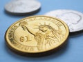 USA coins lie on blue surface. 1 dollar coin close up. Statue of Liberty. Sign of national currency. American economy and money. Royalty Free Stock Photo