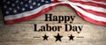 United States flag with happy labor day message placed on wooden background. 3d illustration