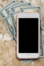 USA currency. Dollars. Blank cel phone screen and bills on marble. Royalty Free Stock Photo