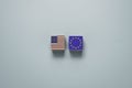 USA and Euro flag print screen on wooden block cubes with blue background. It is symbol of economic tariffs trade war and tax Royalty Free Stock Photo