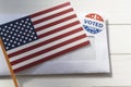 USA flag and Envelope with voting ballot papers sent by mail for absentee vote in presidential election. Top view with copy space Royalty Free Stock Photo