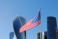 Usa flag fluttering on flagpole against the background of Moscow City Royalty Free Stock Photo
