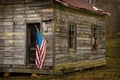 USA Flag Hangs From an Old Cabin Horizontal