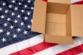 USA flag and open shipping box. Delivery from the USA. Royalty Free Stock Photo