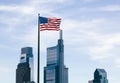 The USA flag overlooking skyscrapers background Royalty Free Stock Photo