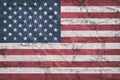 USA flag on stone wall, grunge background. USA flag depicted in bright paint colors