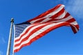 USA flag waving against clear blue sky on bright sunny day Royalty Free Stock Photo