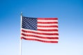 USA flag waving in the wind against blue sky on a sunny day Royalty Free Stock Photo