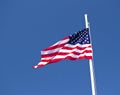 Usa flag waving in the wind with blue sky as background