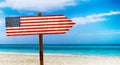 USA flag on wooden table sign on beach background. It is summer sign of USA