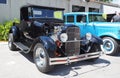 Black Custom rod based of 1929 Ford model A, another model A in blue on the background