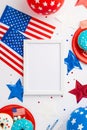 USA Independence Day concept. Top view vertical photo of photo frame national flags balloons stars plates with donuts and confetti