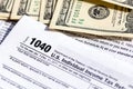 USA 1040 Individual Income Tax Return Form with one hundred dollar bills Royalty Free Stock Photo