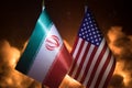 USA and Iran small flags on burning dark background. Concept of crisis of war and political conflicts between nations