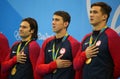 USA Men's 4x100m medley relay team Cory Miller (L), Michael Phelps and Nathan Adrian celebrate victory