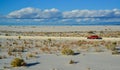 red car rides the harms of sand dunes from gypsum to White Sands National Monument