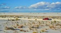 red car rides the harms of sand dunes from gypsum to White Sands National Monument