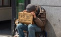 New York, Manhattan downtown. Homeless man holding a cardboard sign, begging Royalty Free Stock Photo