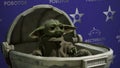 USA, New York - May 7, 2022: robot exhibition with realistic baby Yoda. HDR. Grogu moving its head and sitting in a