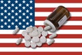 USA opioid crisis prescription bottle with pills on American flag