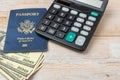 USA passport and 100 dollar notes. Top wiew. Copy space. Concept of recreational and business travel. Calculator to calculate the Royalty Free Stock Photo