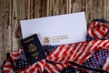 USA passport and naturalization certificate of citizenship US flag over wooden background