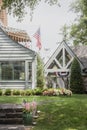 USA Patriotic banners and flags on pretty vintage upscale house with nice landscaping - back yard