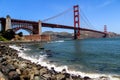USA San Francisco June 2018: Photo of the attractions of the Golden Gate Bridge near the water with stones