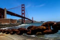 USA San Francisco June 2018: Photo of the attractions of the Golden Gate Bridge near the water with stones and chain
