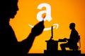 USA, SEATTLE, JANUARY 30, 2023: Amazon. The Intersection of Personal and Professional: Silhouette of Man and Web Developer