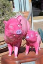 Sculptures of pink pigs on the central street of the city