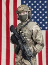 USA soldier with machine gun in hand and American flag on background Royalty Free Stock Photo