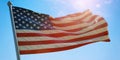USA United States of America flag waving on blue sky background, sunny day Royalty Free Stock Photo