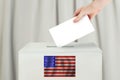 USA Vote concept. Voter hand holding ballot paper for election vote on polling station Royalty Free Stock Photo