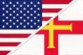 USA vs Bailiwick of Guernsey national flag from textile. Relationship between american and european countries