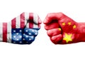 USA vs CHINA confrontation, religious conflict. Men's fists with painted flags of USA and CHINA.