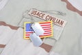 USACE CIVILAN branch tape with dog tags and flag patch on desert camouflage uniform Royalty Free Stock Photo