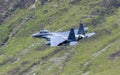 USAF F-15E Strike Eagle flying through the Mach Loop Royalty Free Stock Photo