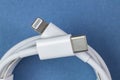 USB-C to Lightning cable on blue, close-up Royalty Free Stock Photo