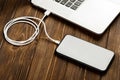 A USB cable connects your phone and laptop Royalty Free Stock Photo