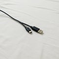 A USB cable featuring two connectors: USB Type-A and Micro USB. The cable is black, Royalty Free Stock Photo