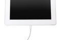 USB cable with lightning connector and tablet on white background, top view Royalty Free Stock Photo