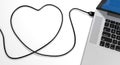 A usb cable plugged into a laptop, draw the shape of a heart Royalty Free Stock Photo